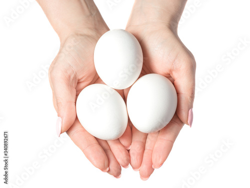Woman hands with white eggs isolated on white background