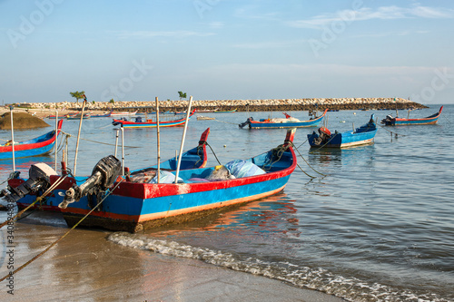 Timber fishing boats moored on the beach Penang