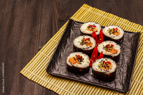 Korean roll Gimbap(kimbob). Steamed white rice (bap) and various other ingredients. Trendy black background