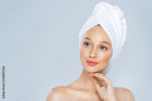 Beautiful woman in a white towel on a head.