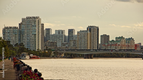 Nagatino district modern buildings on Nagatinsky metro bridge, Moscow river and embankment alley way background at summer evening, capital cityscape, Russia