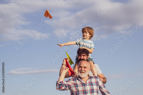 Happy man family have fun together. Kid pilot with toy jetpack against sky background. Family holiday and togetherness. Dad and son. Excited teach.