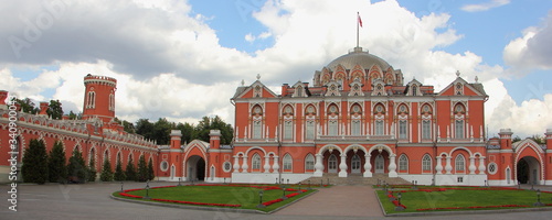Ancient Petrovsky travel Palace Russian landmark panorama near metro Dinamo on Leningradsky Avenue in Moscow, Russia on a summer day on blue sky with clouds backround