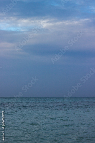 A portrait shot of white sandy beach and clear blue sky