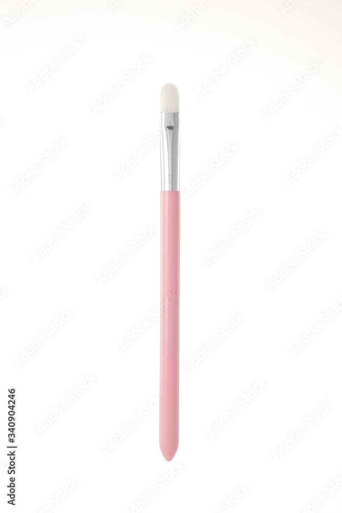 Pink makeup brush with a white background.