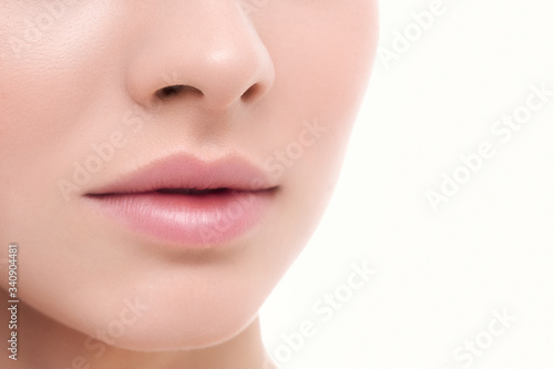 Closeup perfect natural lip makeup. Beautiful plump full lips on female face. Spa tender lips. Blank Space