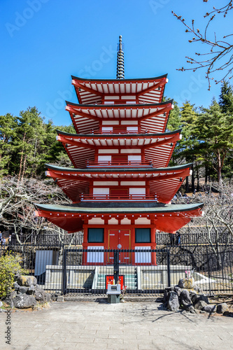 Red wooden pagoda near the Fuji mountain in Japan