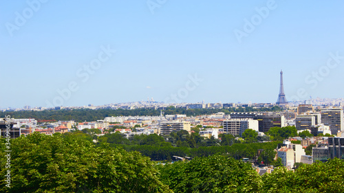 Paris  France - August 26  2019  Paris from above showcasing the capital city s rooftops  the Eiffel Tower  Paris tree-lined avenues with their haussmannian buildings and Montparnasse tower. 16th