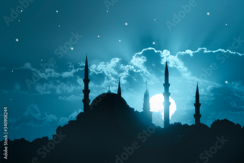Fototapeta A silhouette of a big mosque on Blue full moon in night background