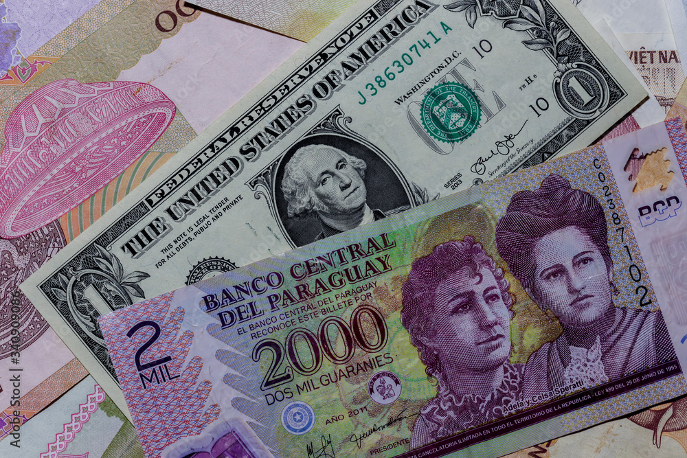 One US Dollar with Different Paraguayan guarani Banknotes Stock Photo
