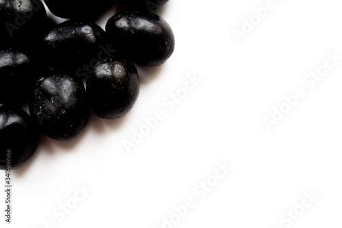 Chocolate coated peanuts on a white background, close-up