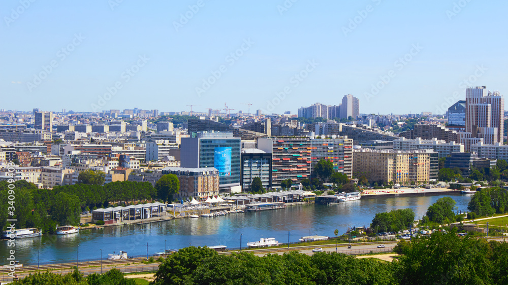 Fototapeta premium Paris, France - August 26, 2019: Paris from above showcasing the capital city's rooftops, the Eiffel Tower, Paris tree-lined avenues with their haussmannian buildings and Montparnasse tower. 16th