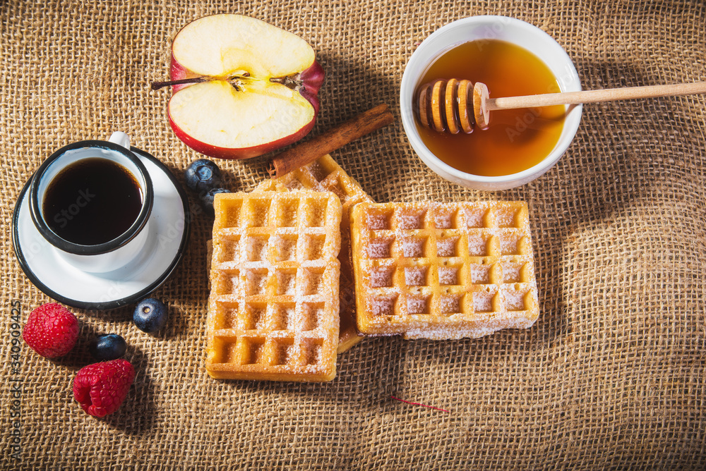 Waffles with fruit, honey and fresh coffee.
