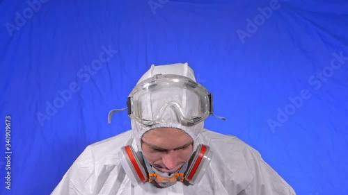 Scientist virologist in respirator. Slow motion. Man close up portrait, wearing protect medical aerosol spray paint mask. Concept health safety N1H1 virus protection coronavirus epidemic 2019 nCoV. photo