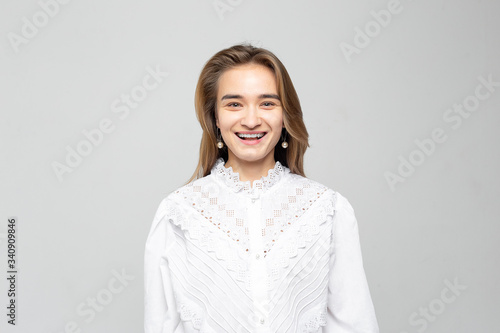 Beautiful young woman portrait. Studio shot, isolated on gray background