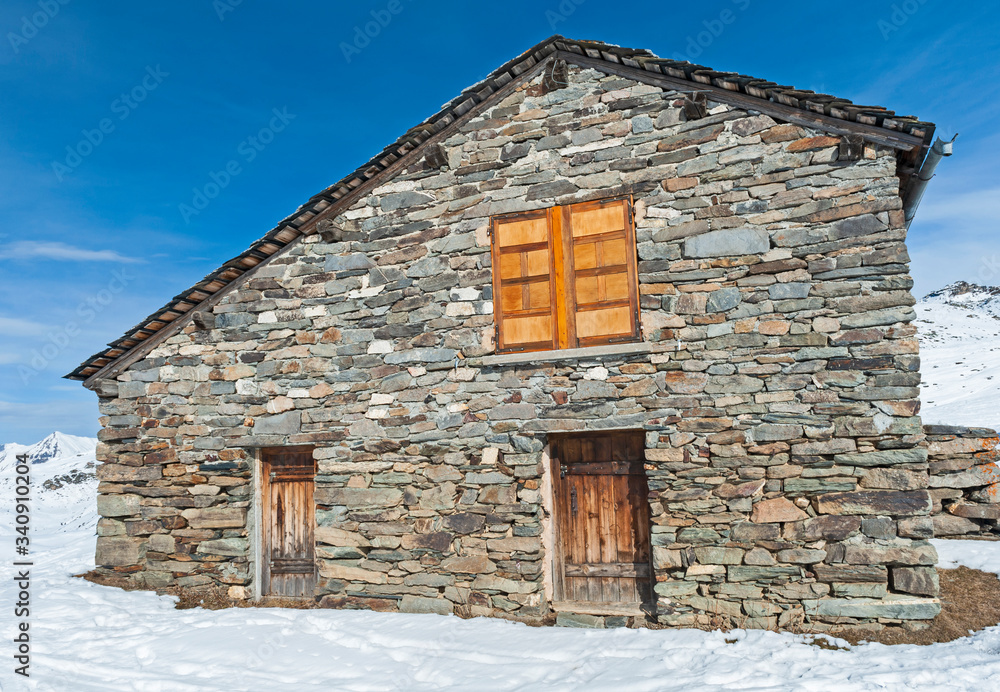 Isolated mountain hut house in the snow