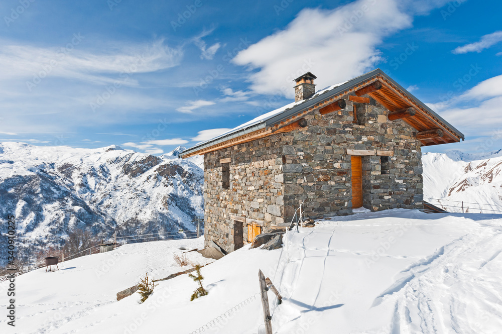 Isolated mountain hut house in the snow