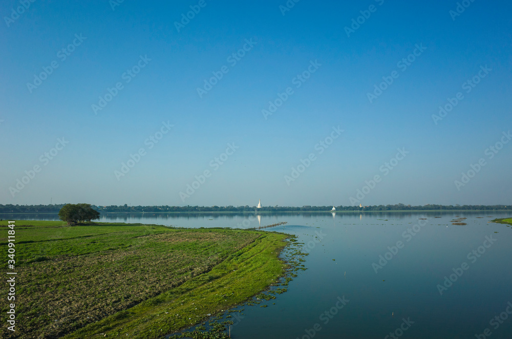 Green field on shore of Taung Tha Man Lake at Amarapura, Mandalay, Myanmar