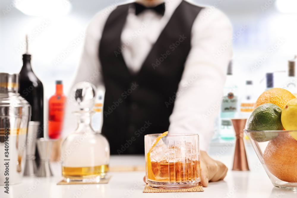 Barman serving whiskey in a bar