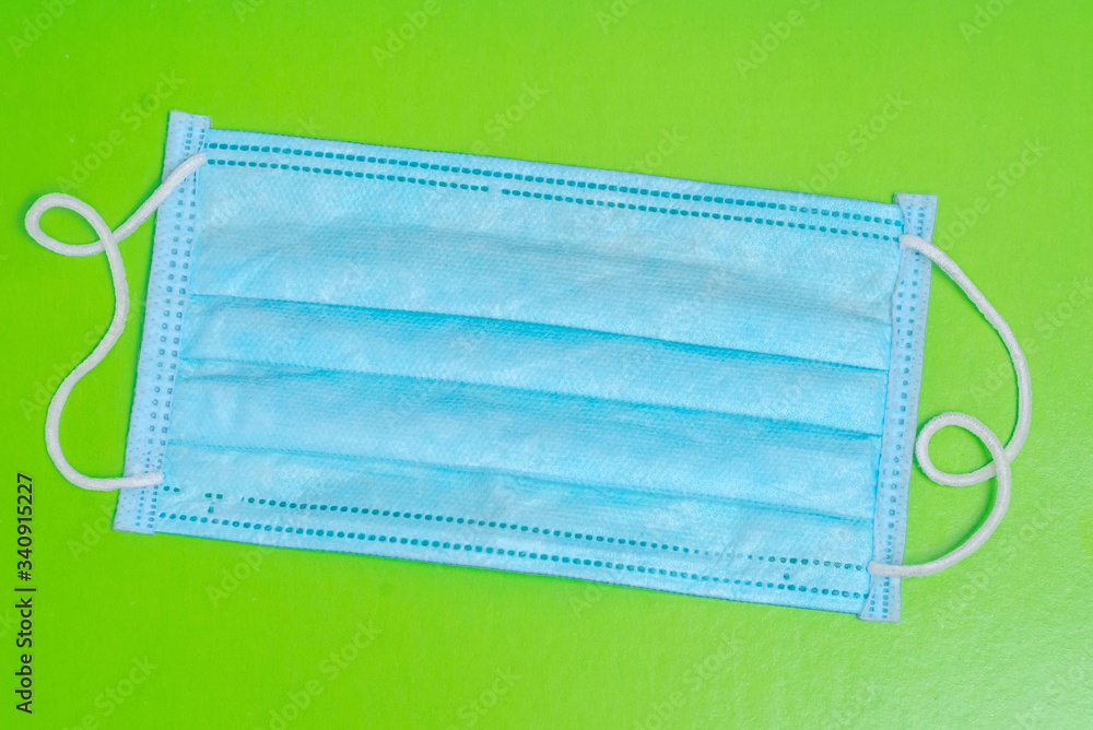 Blue, medical mask n95 on a green background Blue, medical mask n95 on a green background