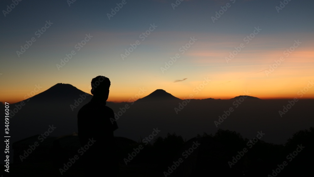 silhouette of a man in the sunset at mount andong