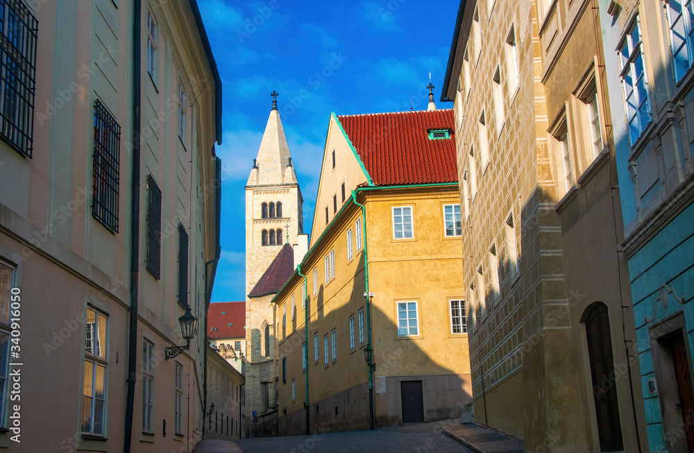 Empty narrow street in Prague castle. Tower of St. George's Basilica on background, Prague, Czech Republic