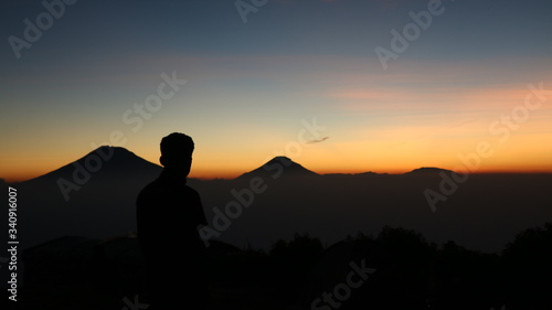 silhouette of a man in the sunset at mount andong