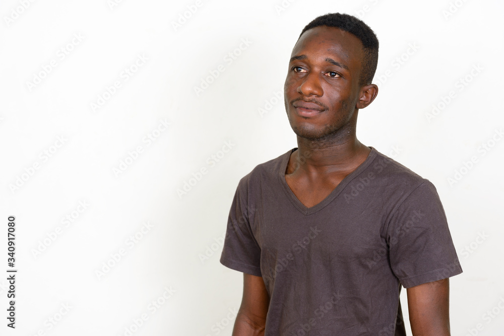 Portrait of young African man thinking and looking up Portrait of young African man thinking and looking up
