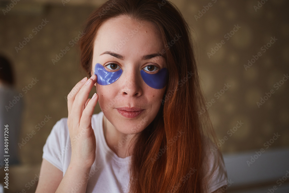 Young attractive woman with mask under eyes. Beautiful female with natural makeup, have collagen patches on fresh facial skin in home. Morning routine Young attractive woman with mask under eyes. Beautiful female with natural makeup, have collagen patches on fresh facial skin in home. Morning routine