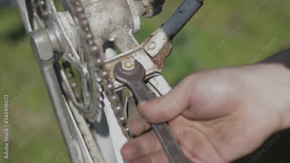 Wrench unscrewing a screw on an old bike. Bicycle repair. Wrench unscrewing a screw on an old bike. Bicycle repair.