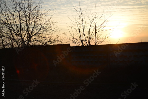 sunset over an old concrete fence