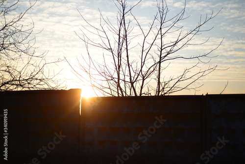 sunset over an old concrete fence