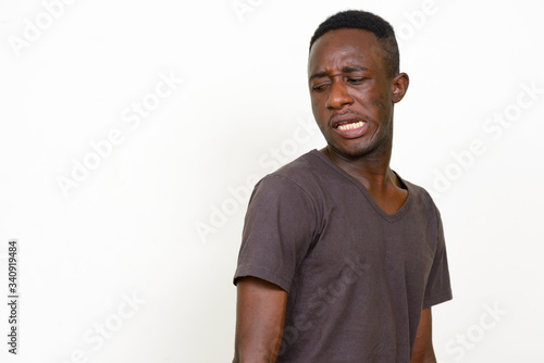 Portrait of stressed young African man looking disgusted