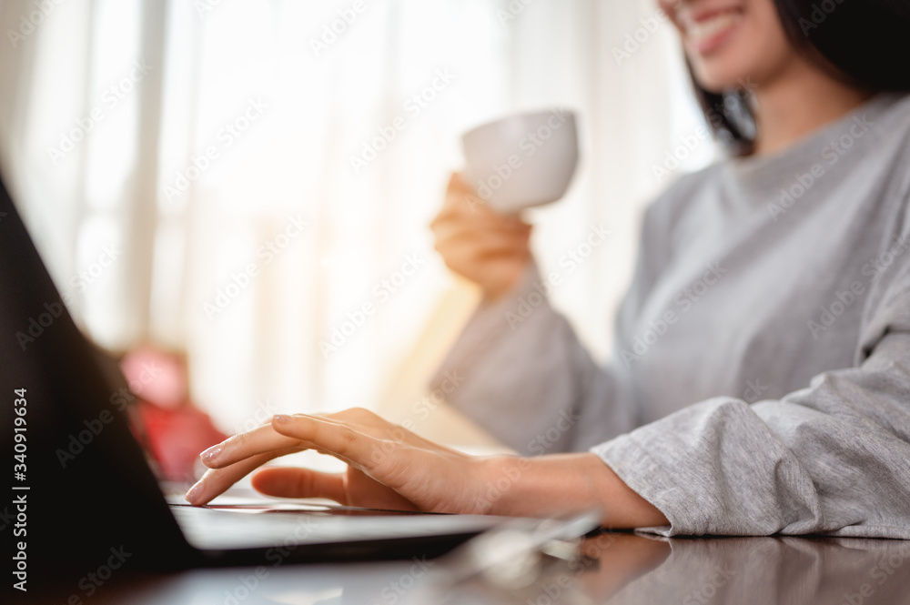 Woman holding a coffee cup work from home wait epidemic situation to improve soon at home. Coronavirus, covid-19, Work from home (WFH), Social distancing, Quarantine, Prevent infection concept. Woman holding a coffee cup work from home wait epidemic situation to improve soon at home. Coronavirus, covid-19, Work from home (WFH), Social distancing, Quarantine, Prevent infection concept.