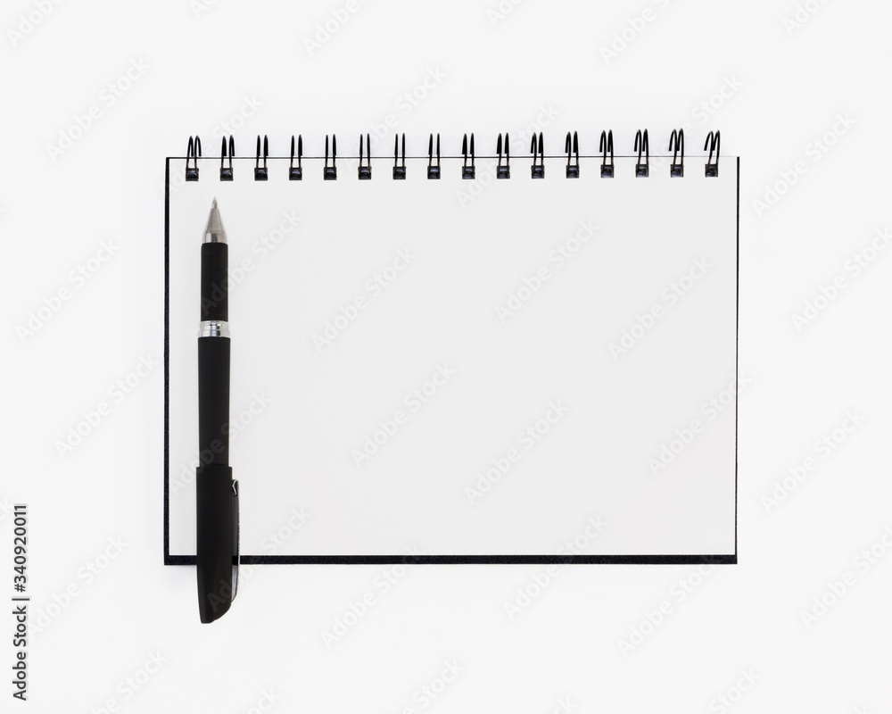 Empty stylish spiral Notepad for notes and a beautiful corporate pen on a white background. Empty space. Stylized stock photos. The view from the top. Empty stylish spiral Notepad for notes and a beautiful corporate pen on a white background. Empty space. Stylized stock photos. The view from the top.