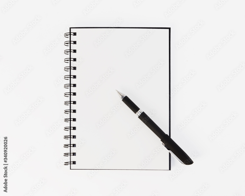Empty stylish spiral Notepad for notes and a beautiful corporate pen on a white background. Empty space. Stylized stock photos. The view from the top. Empty stylish spiral Notepad for notes and a beautiful corporate pen on a white background. Empty space. Stylized stock photos. The view from the top.