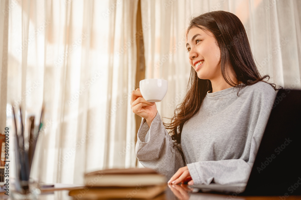 Woman holding a coffee cup work from home wait epidemic situation to improve soon at home. Coronavirus, covid-19, Work from home (WFH), Social distancing, Quarantine, Prevent infection concept.