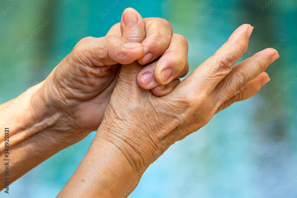 Fototapeta premium Senior woman's hands washing her hands in step 5 on bokeh blue pool background, Close up & Macro shot, Selective focus, Prevention from covid19, Bacteria, healthcare concept, 7 step wash hand