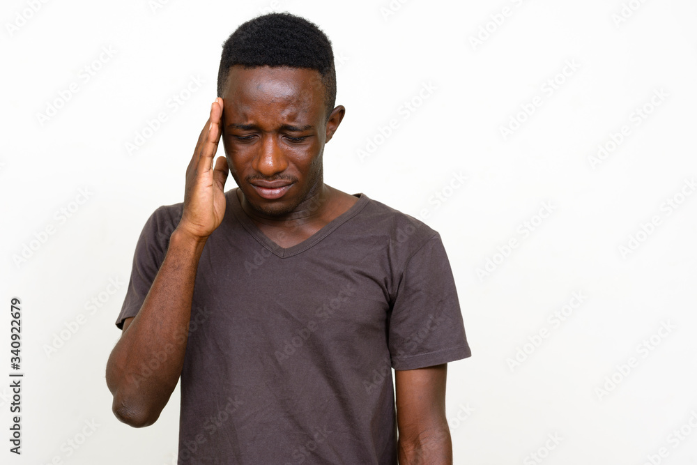 Portrait of stressed young African man having headache Portrait of stressed young African man having headache
