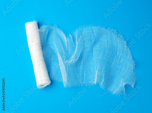 roll of white gauze bandage on a blue background photo