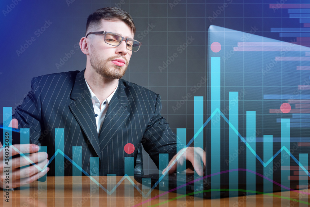 Young scientist on the background of graphs. Dynamics of economic indicators. Statistics. Exchange trade. Mathematical analysis. A man at a laptop against the background of stock information. Young scientist on the background of graphs. Dynamics of economic indicators. Statistics. Exchange trade. Mathematical analysis. A man at a laptop against the background of stock information.