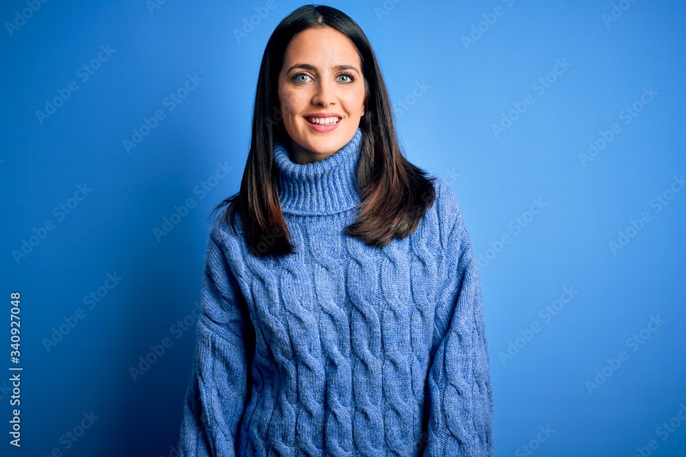 Young brunette woman with blue eyes wearing casual turtleneck sweater with a happy and cool smile on face. Lucky person. Young brunette woman with blue eyes wearing casual turtleneck sweater with a happy and cool smile on face. Lucky person.