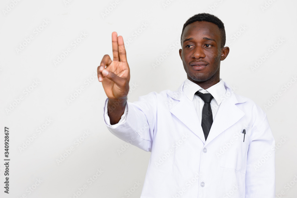 Portrait of young African man doctor touching something Portrait of young African man doctor touching something