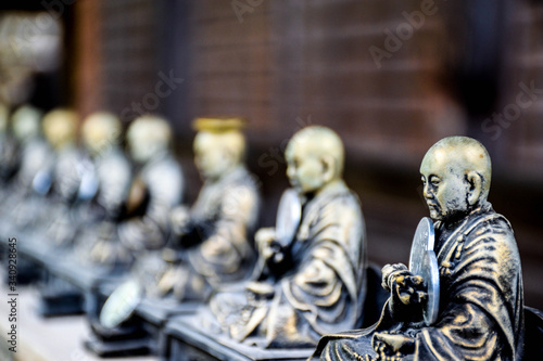 Small holy bronze statuettes in a shrine somewhere in Hiroshima prefecture, Japan