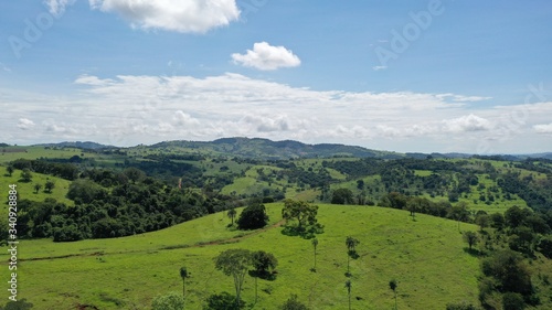 Brazilian farm with pastureland among mountains and native Cerrado vegetation. Ceres, Goias State, Brazil 