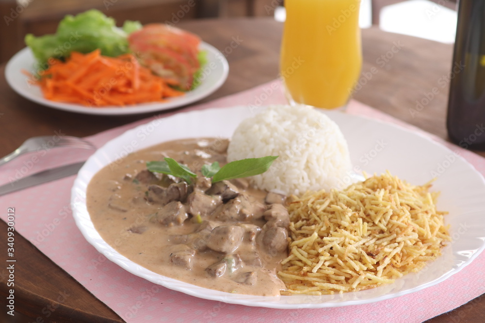 beef stroganoff Beef with white rice and straw potatoes on a white plate
beef stroganoff Beef with white rice and straw potatoes on a white plate