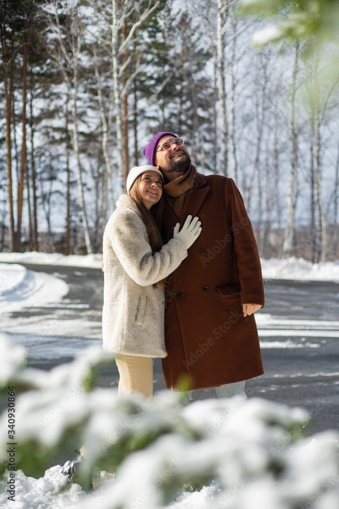 young couple enjoying winter park young couple enjoying winter park