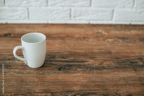 White cup on a wooden table