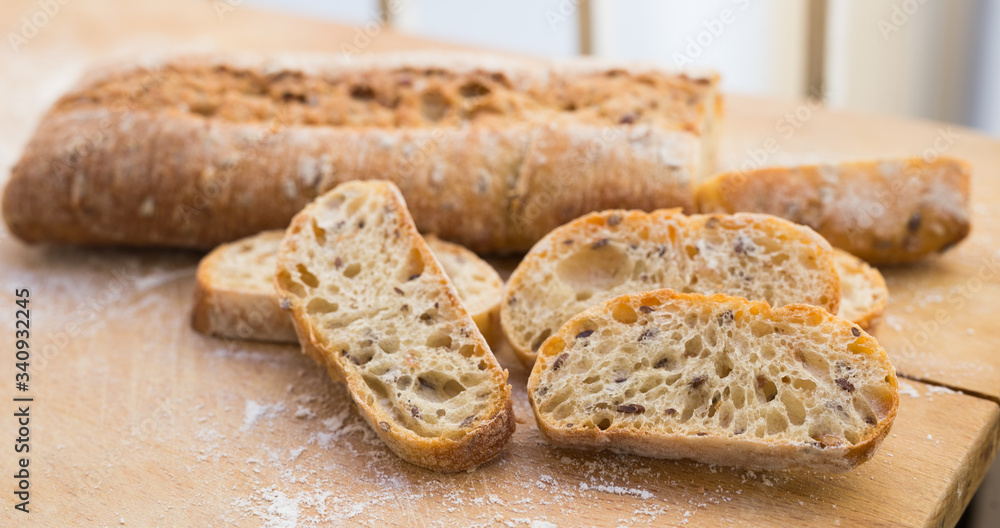fresh loaf of bread on wooden board