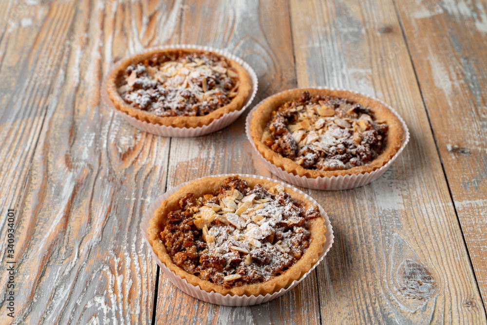 Homemade tartlet with nuts and honey on rustic wooden table
